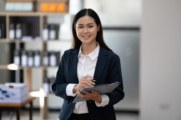 A professional field sales representative standing.