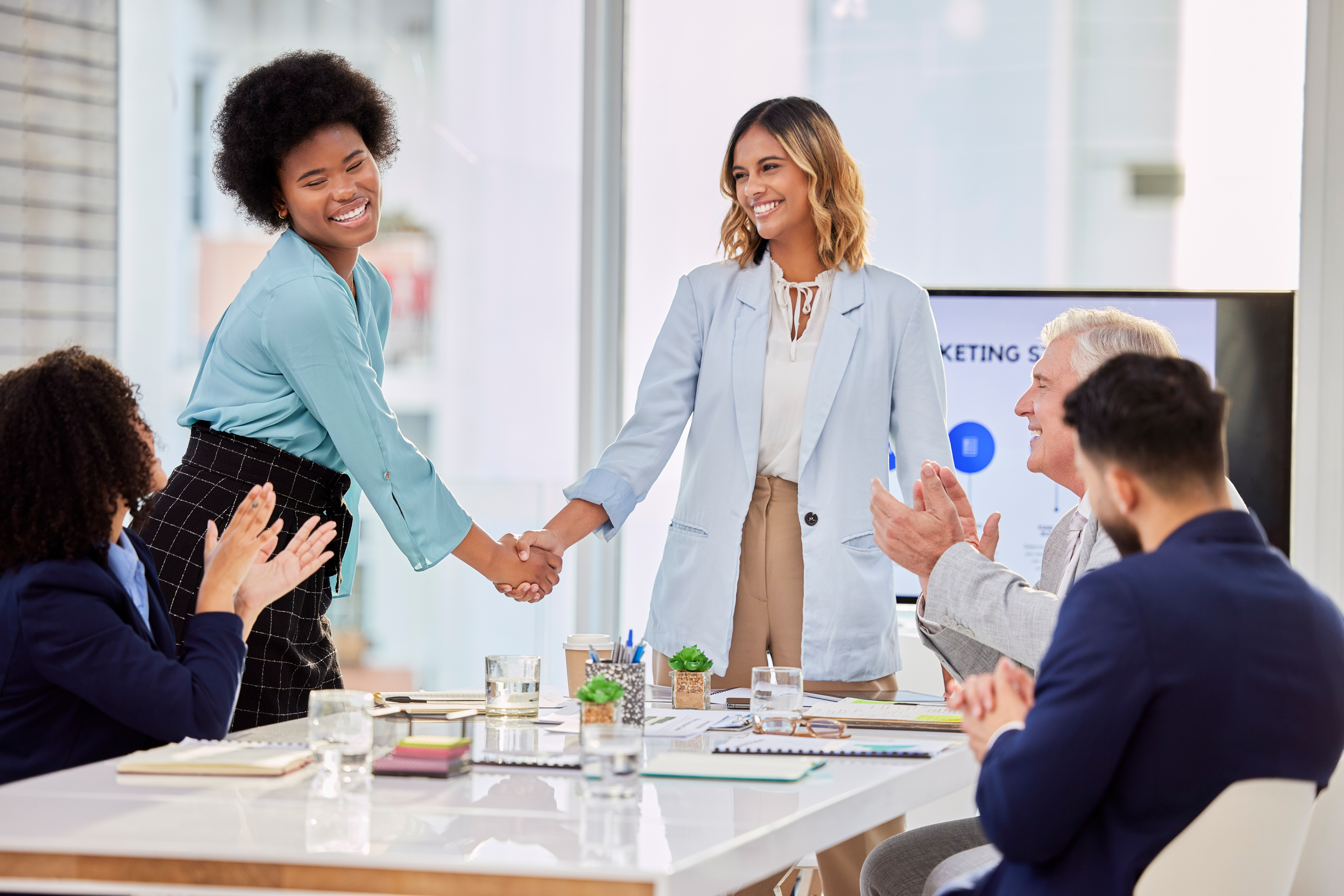 Diverse professionals applauding teamwork and growth in entry-level marketing jobs